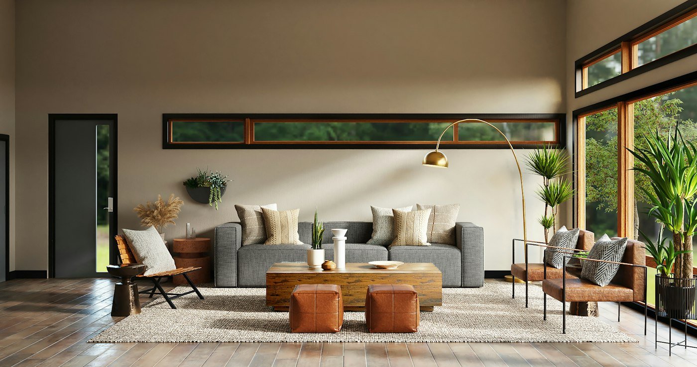 Grey sofa and brown leather chairs in a room with a high window